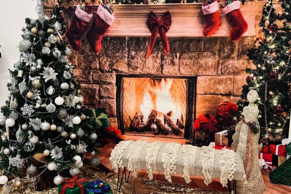 a fireplace with stockings and christmas tree