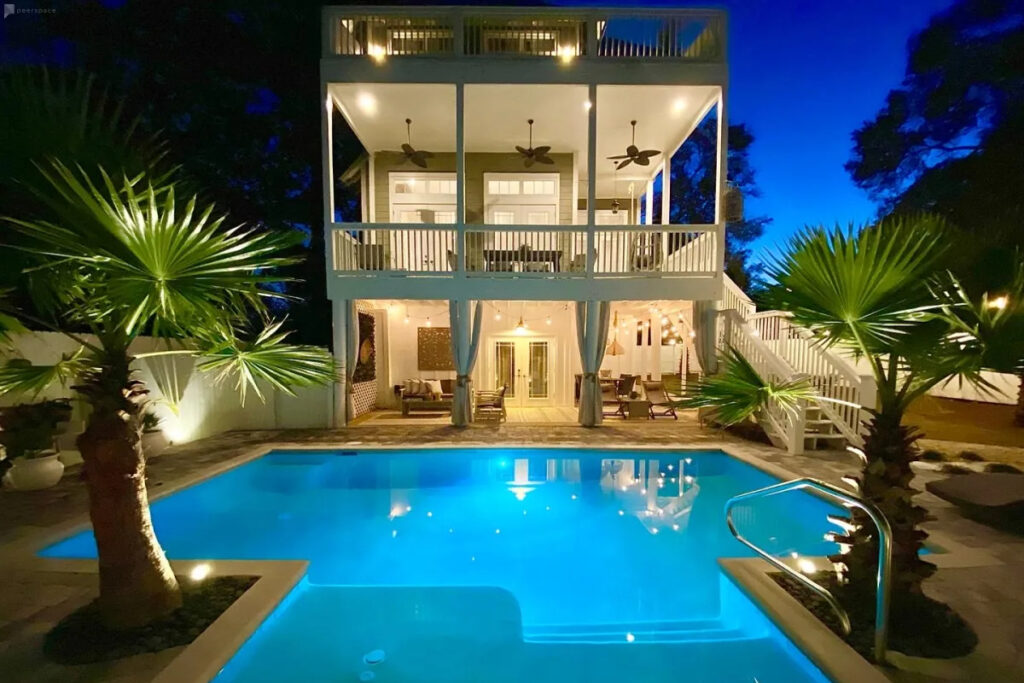 a modern three-story home with a pool