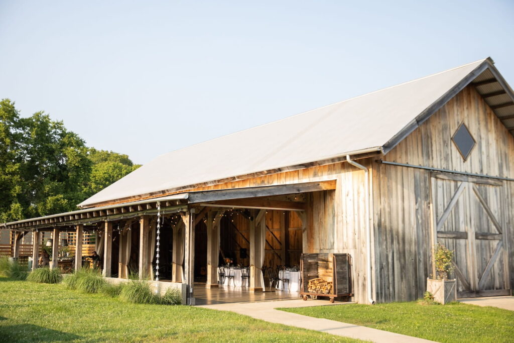 Party space in a barn in Nashville with open veranda and banquet tables set up inside
