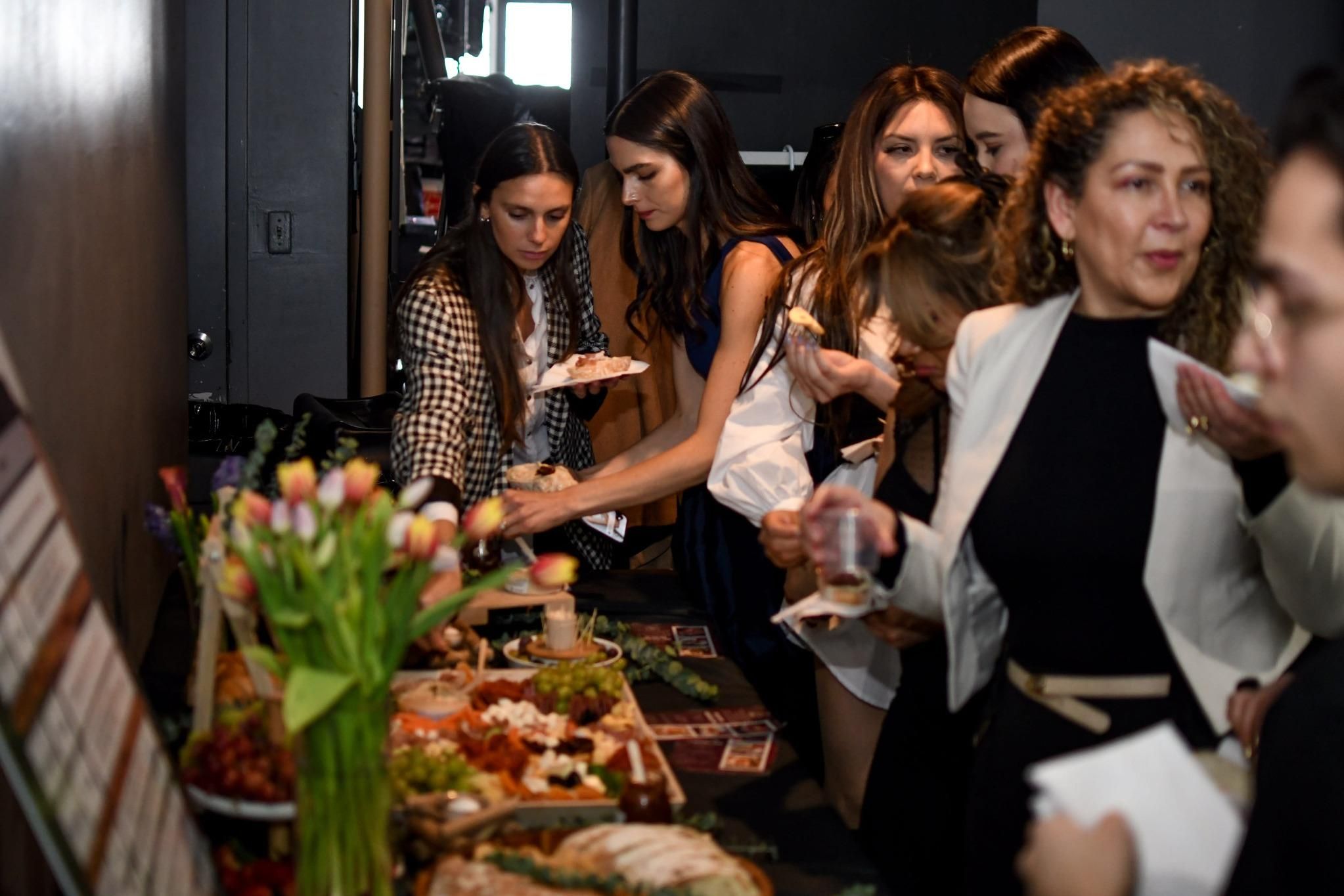 Guests browsing catered food display at Brooklyn party planner event