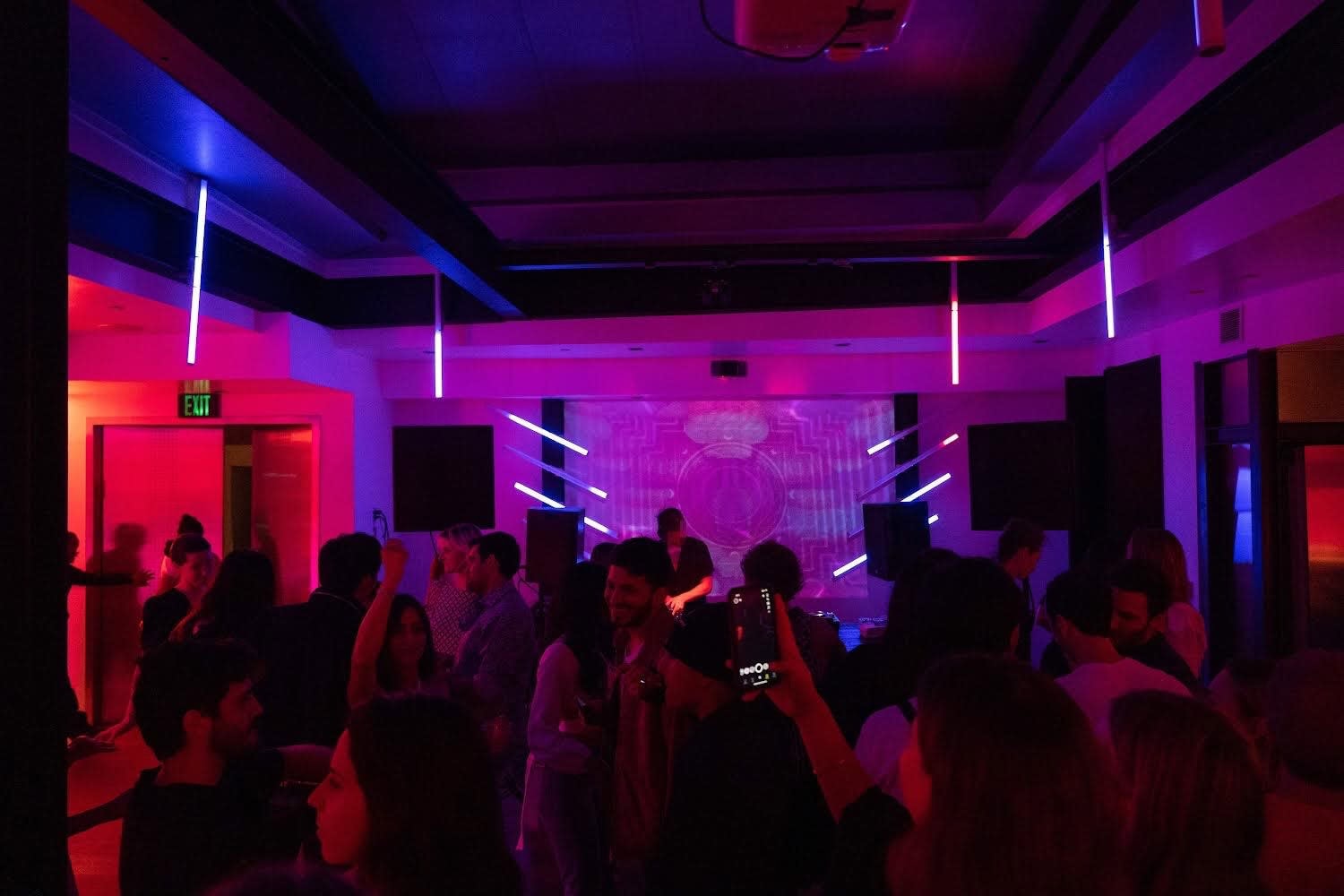 High-energy California nightlife party venue with neon lighting and crowd