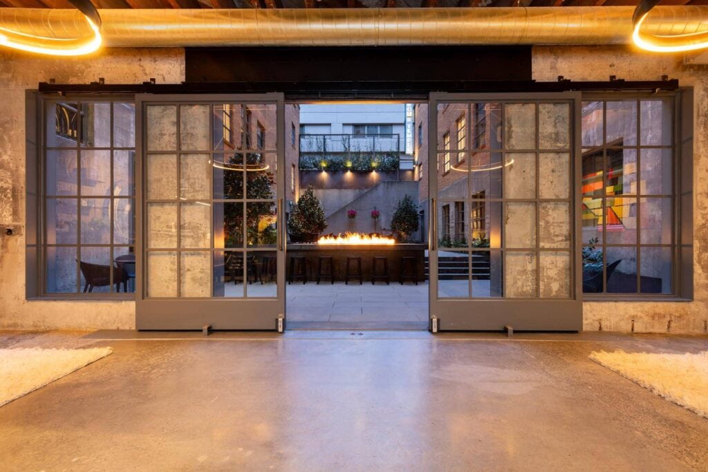 Open barn doors revealing outdoor firepit party space in Chicago