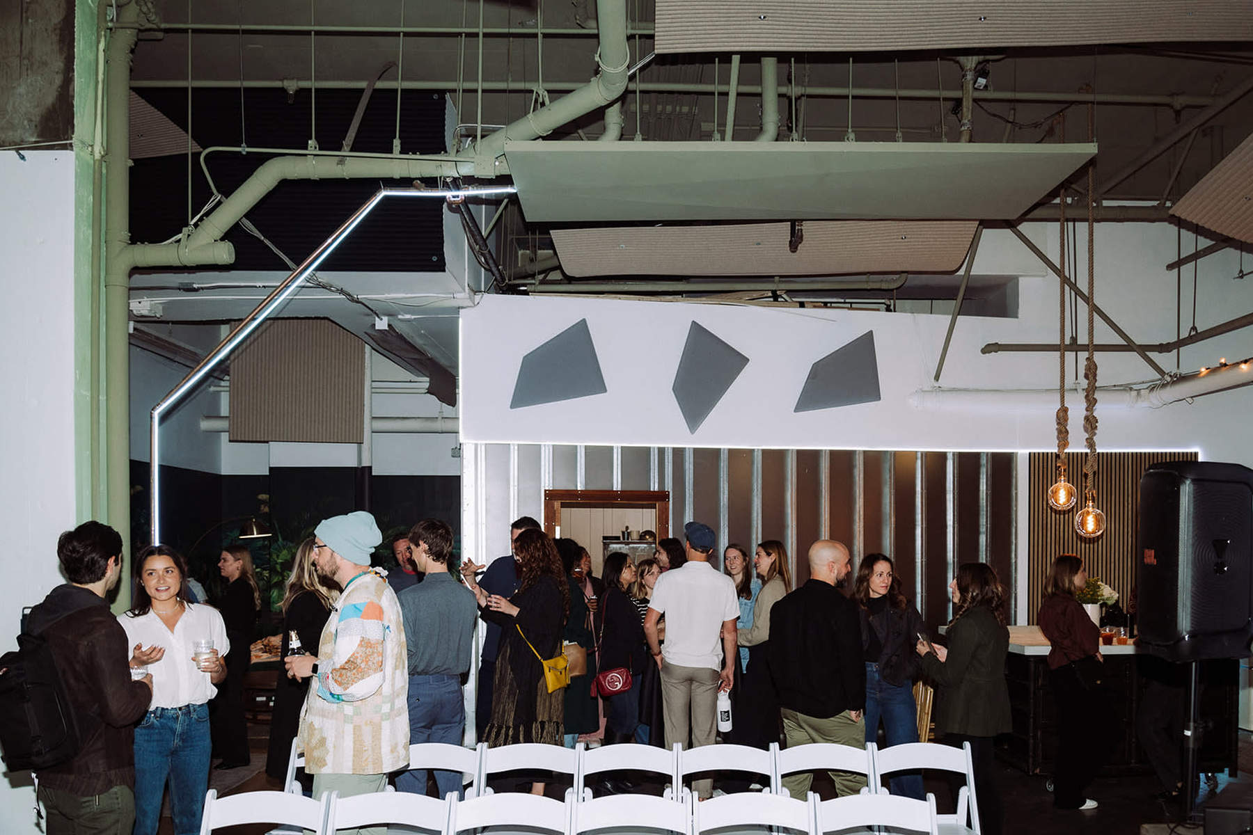Guests mingling in modern industrial Detroit party venue space