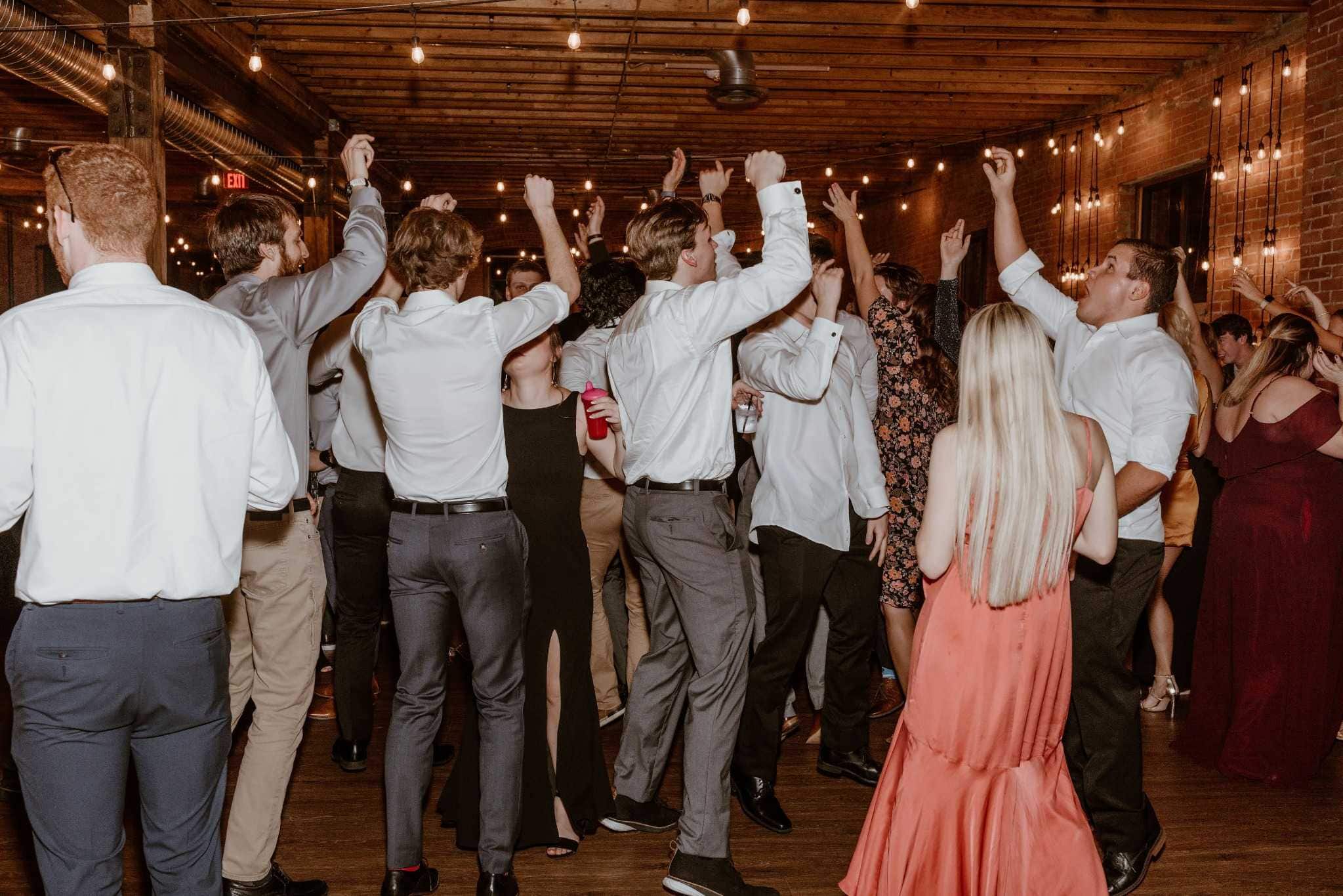 Guests dancing at a lively Kansas party in a brick venue