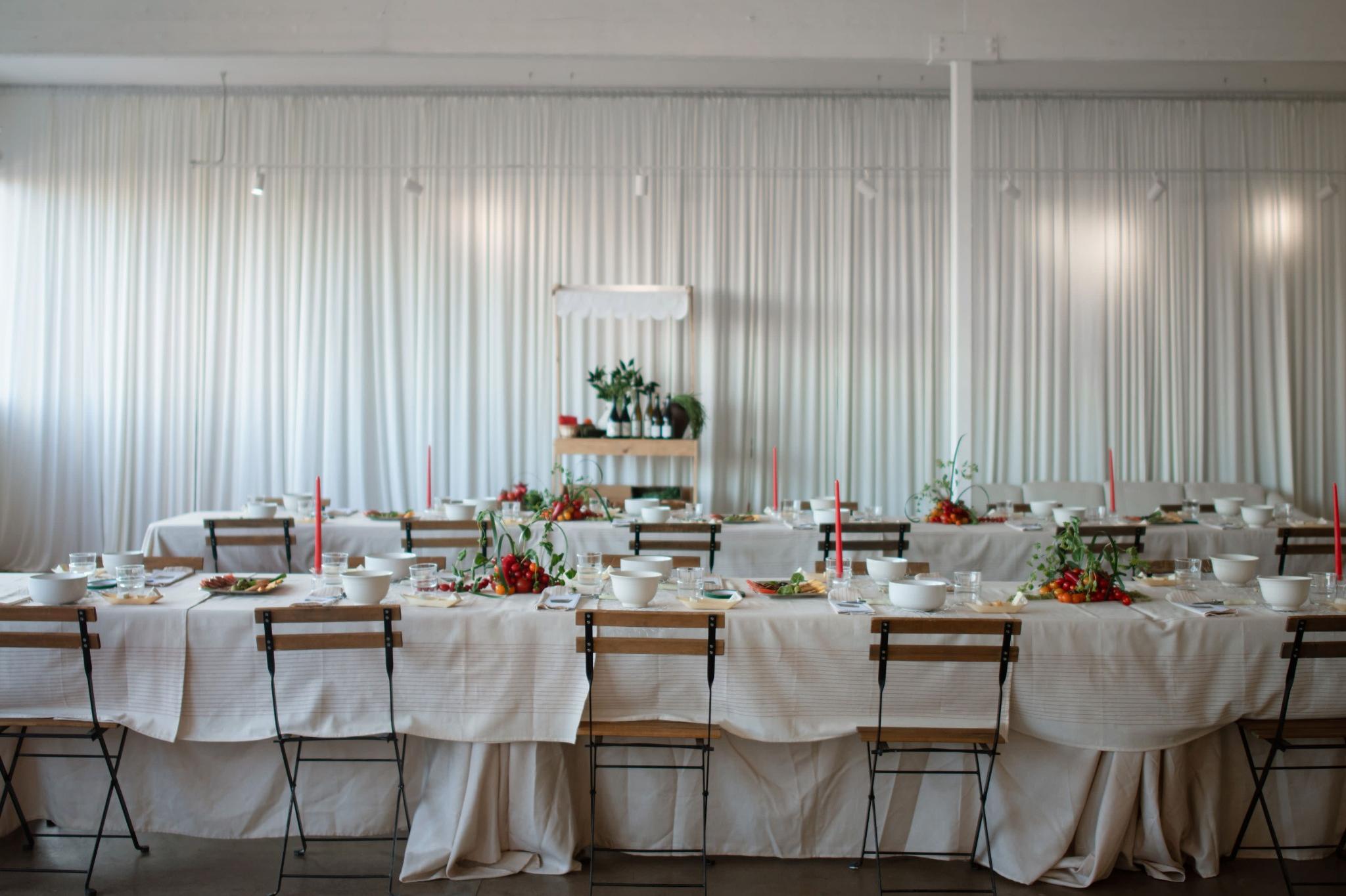 Polished banquet tables with florals and candles styled by Milwaukee party planners