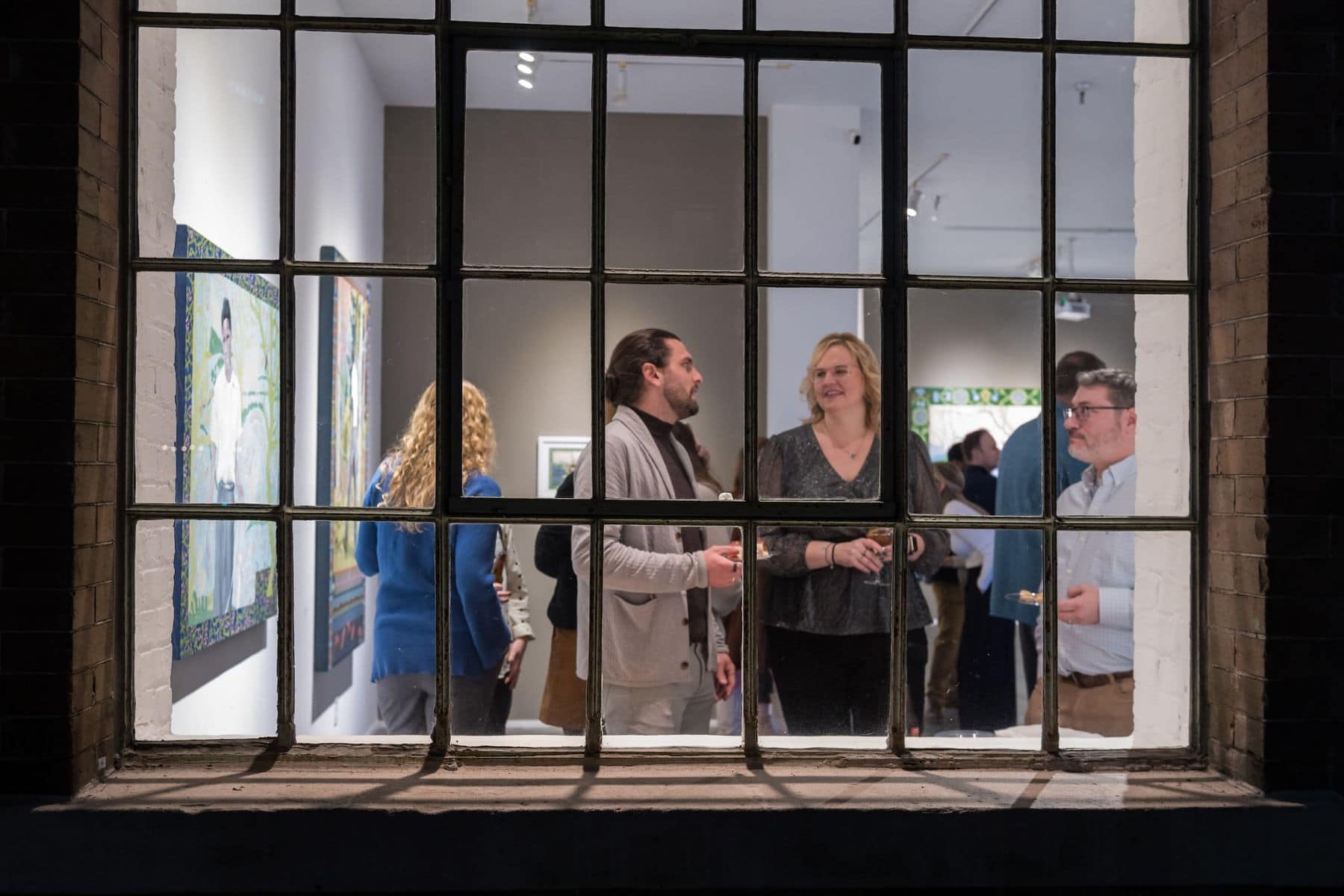Visitors viewing art inside a New Orleans gallery event space