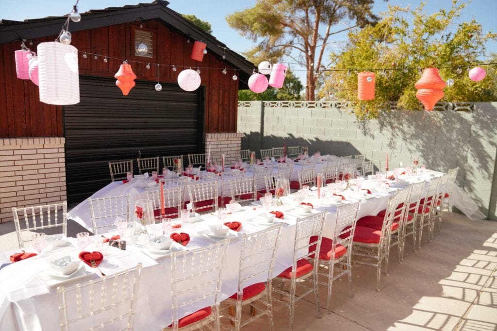 Outdoor table with balloons and white cloth set up by San Antonio party planners