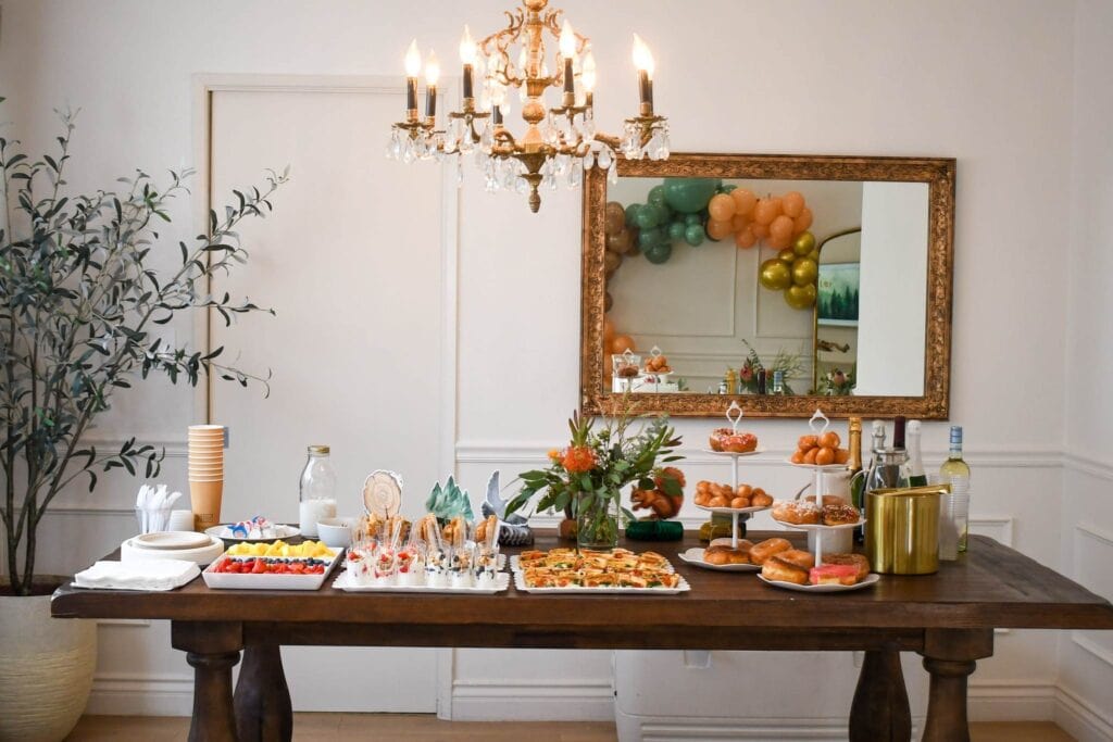 Indoor setup for party with food and chandelier designed by San Antonio party planner 