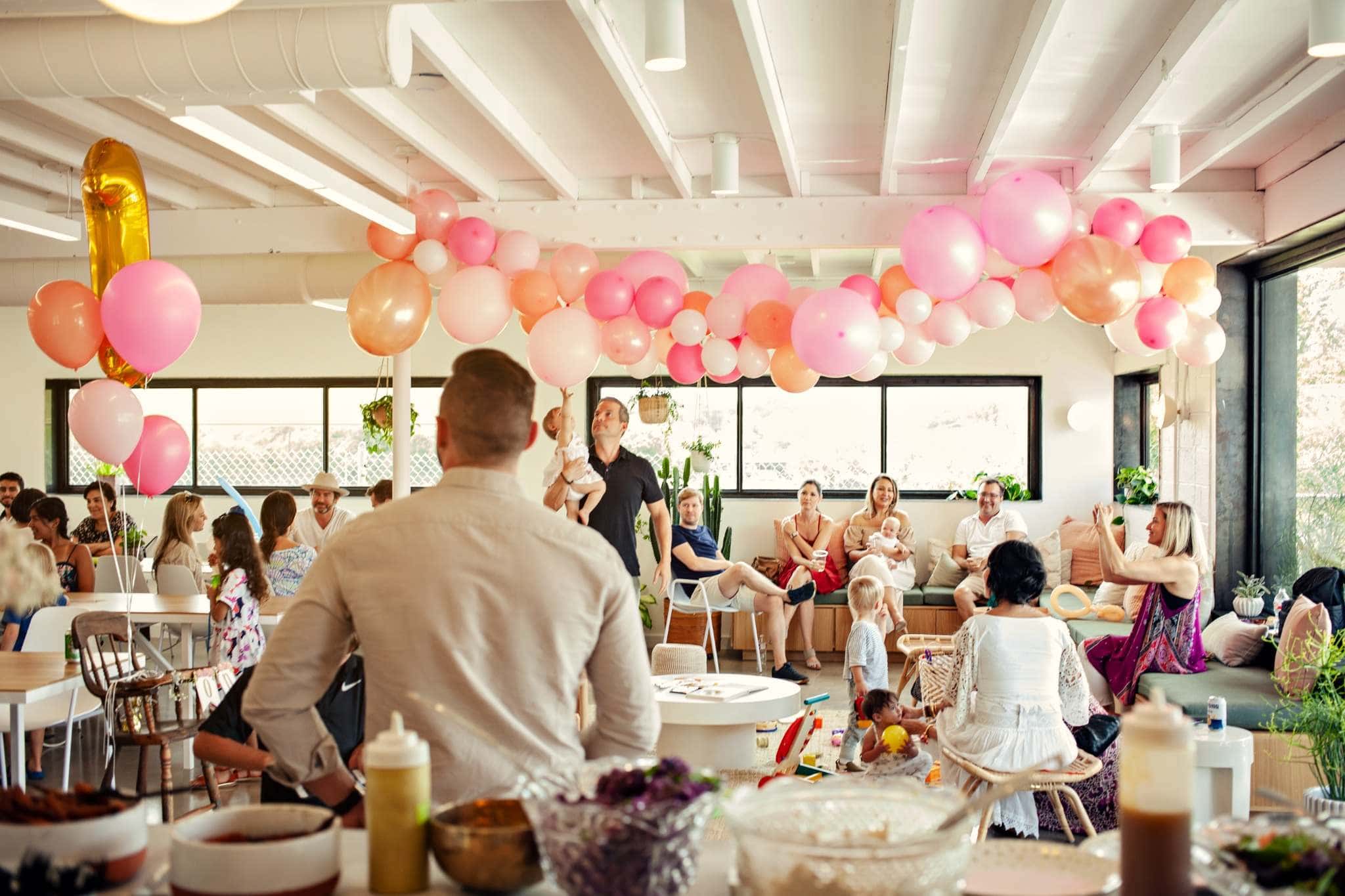 Lively San Diego birthday celebration with balloons and guests mingling