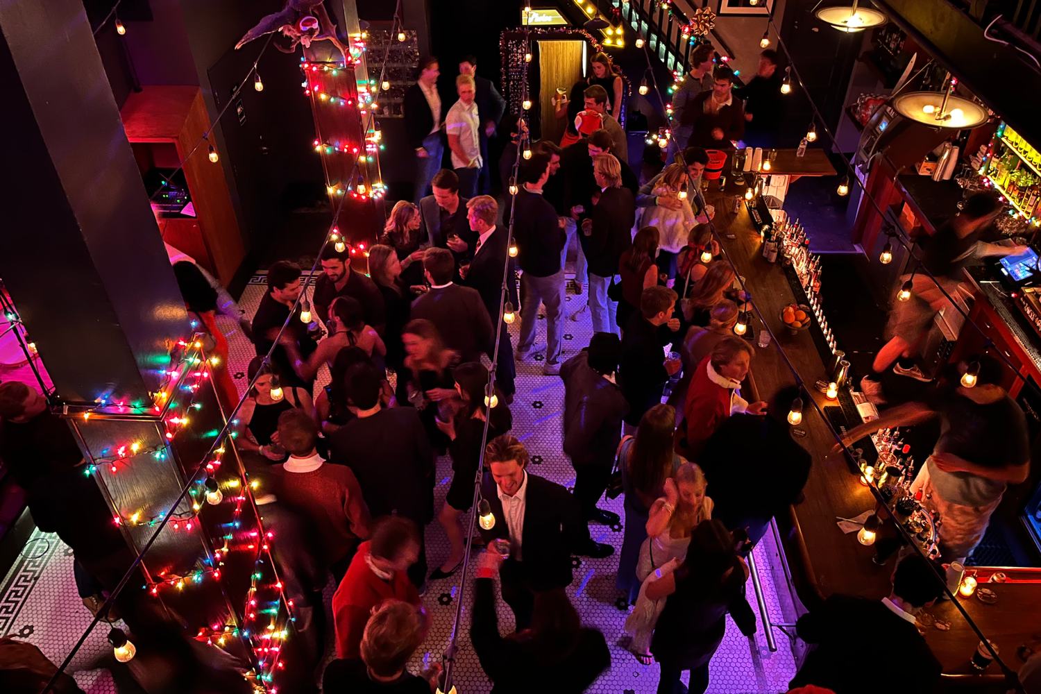 Overhead view of festive San Francisco party crowd with colorful lights