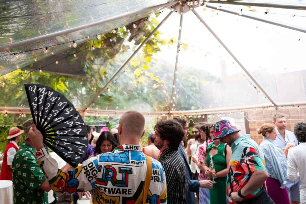 Indoor party under clear tent and guests designed by party planner in Tampa