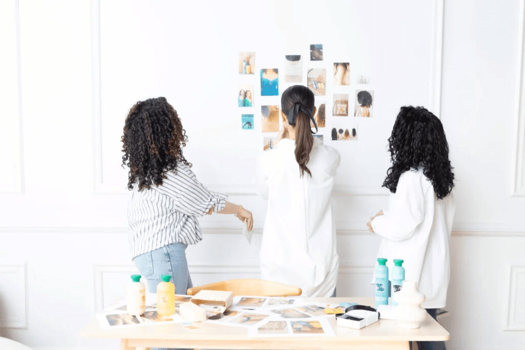 three women working on an art project