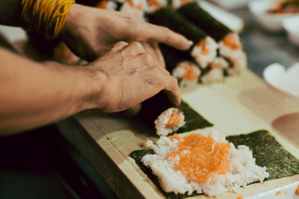 person rolling sushi