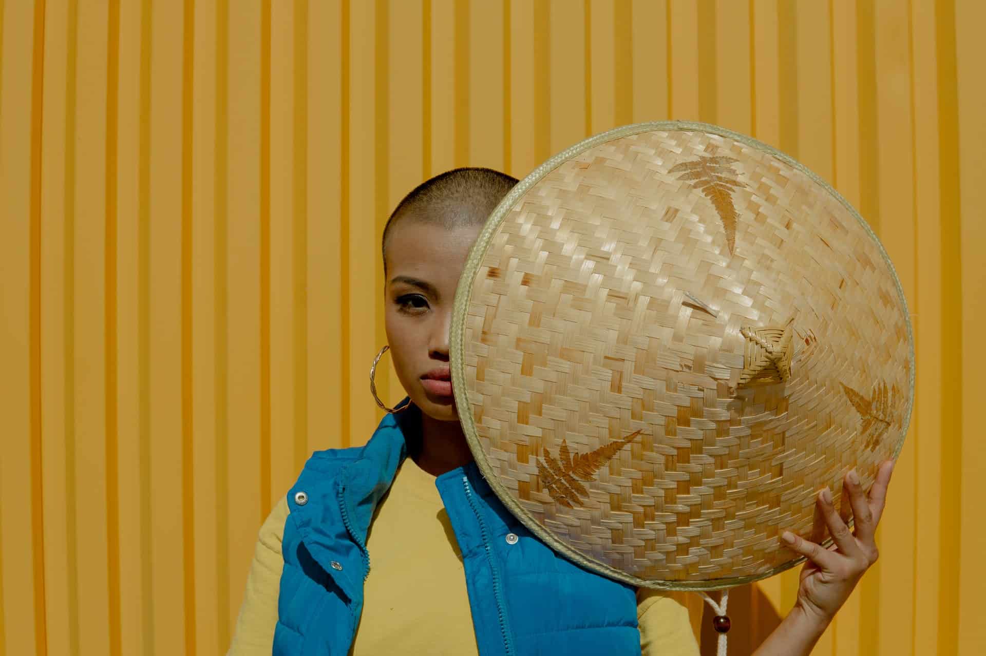 portrait of woman holding a vietnamese hat