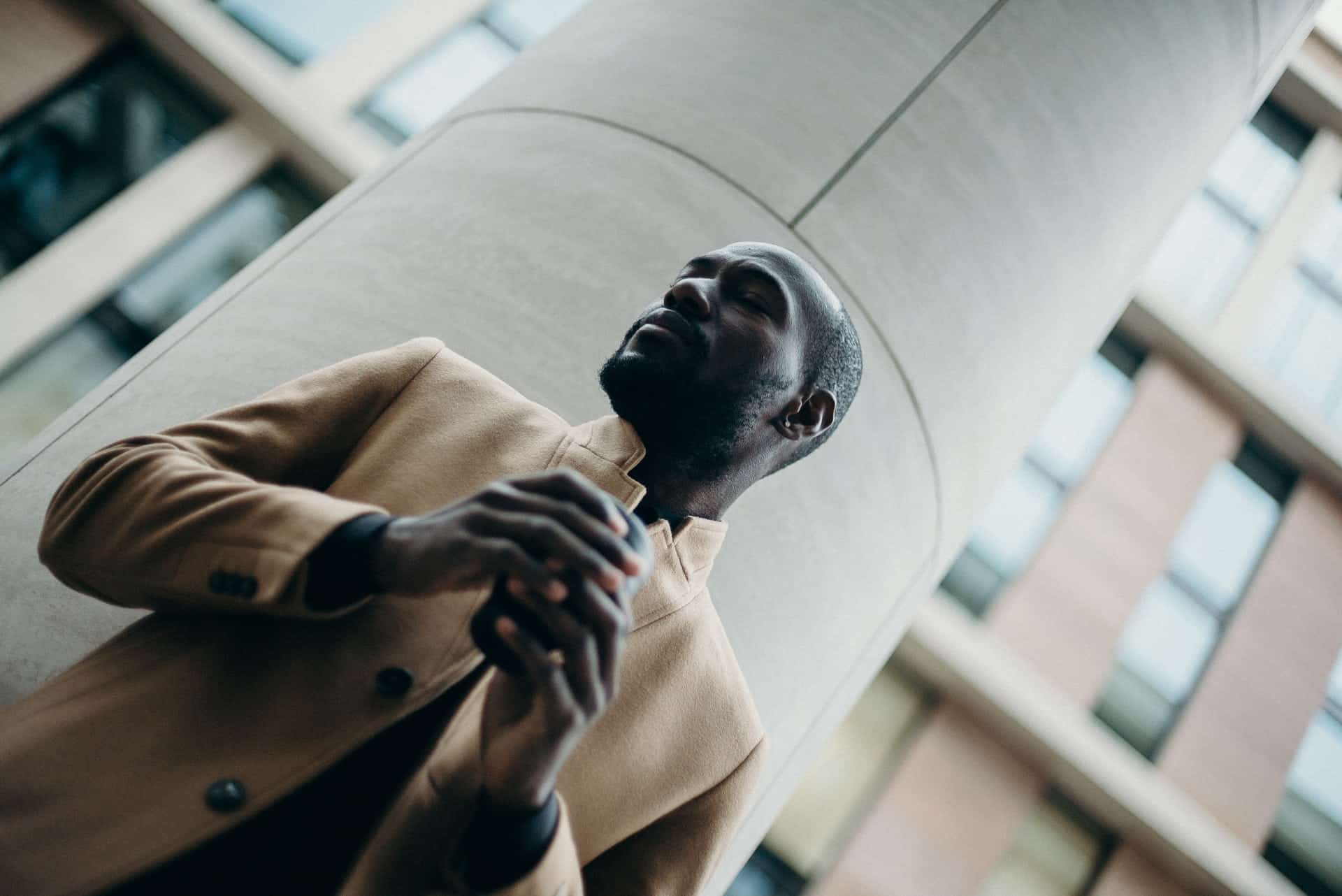 dutch-angle photo of man in a coat