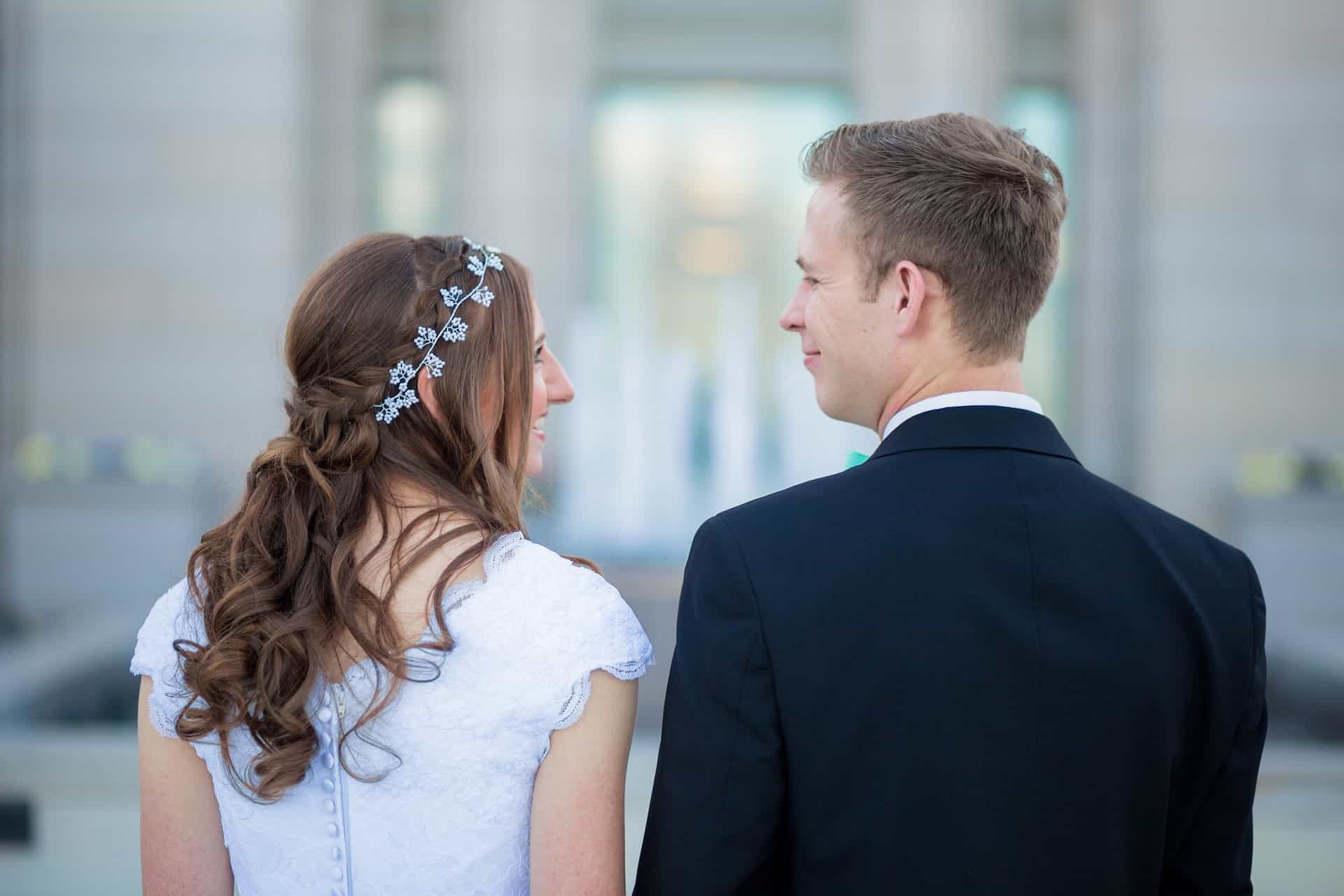 bride and groom smiling at each other