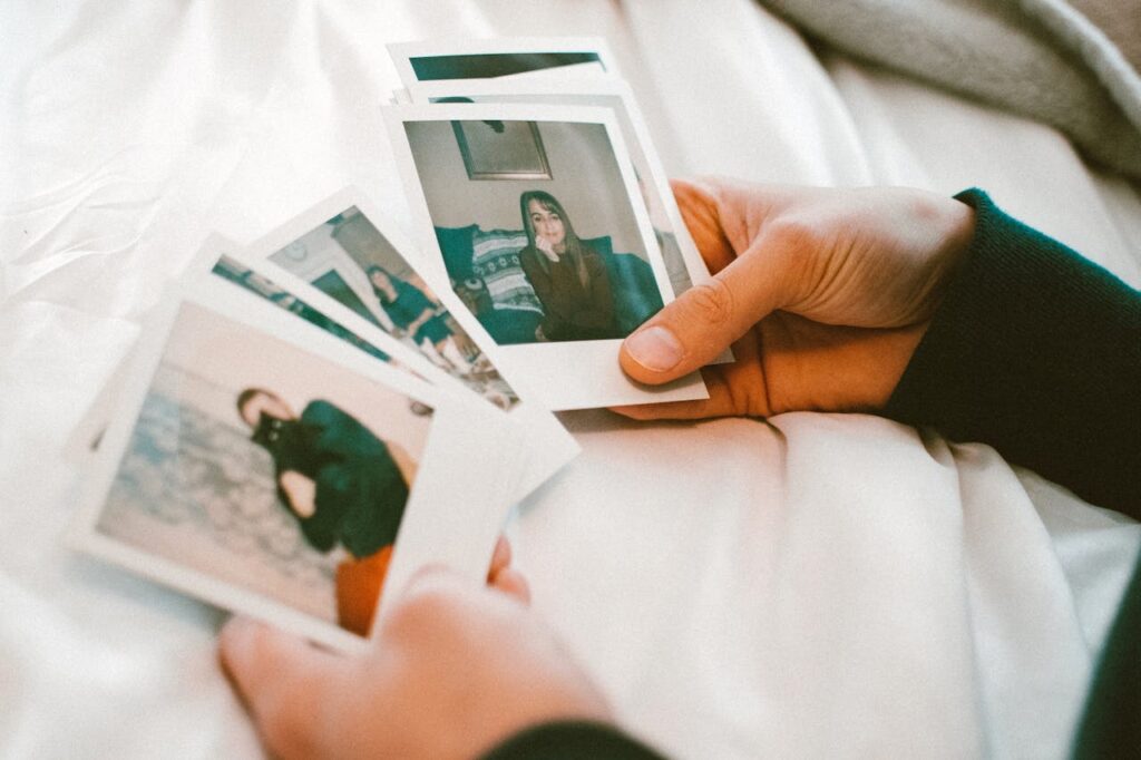 Person holding polaroid photos for Friendsgiving party favors