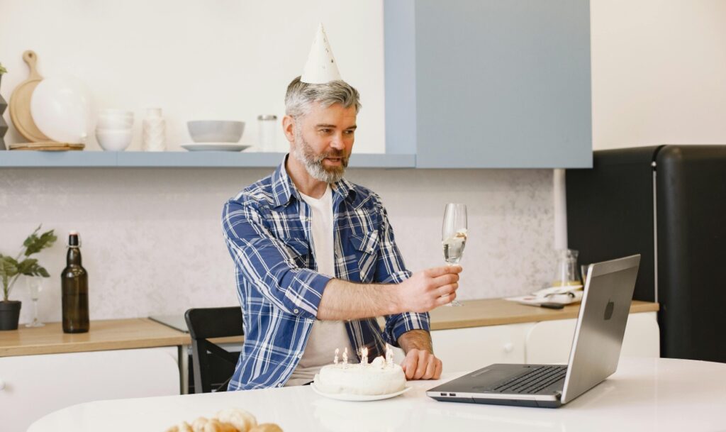 man toasting during virtual party