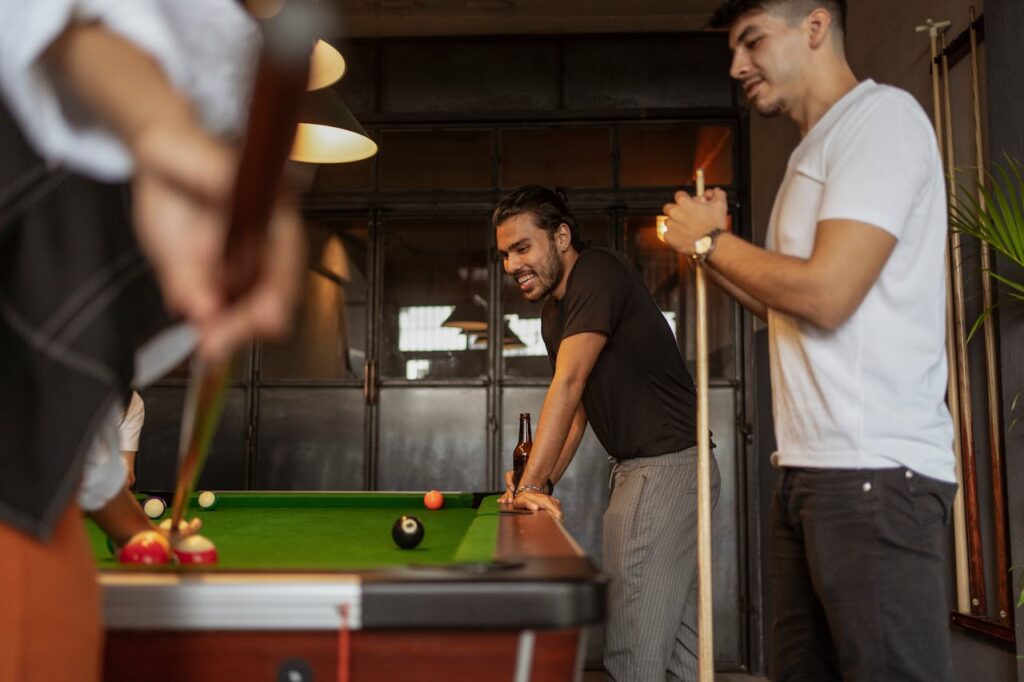 Friends playing pool at a divorce party