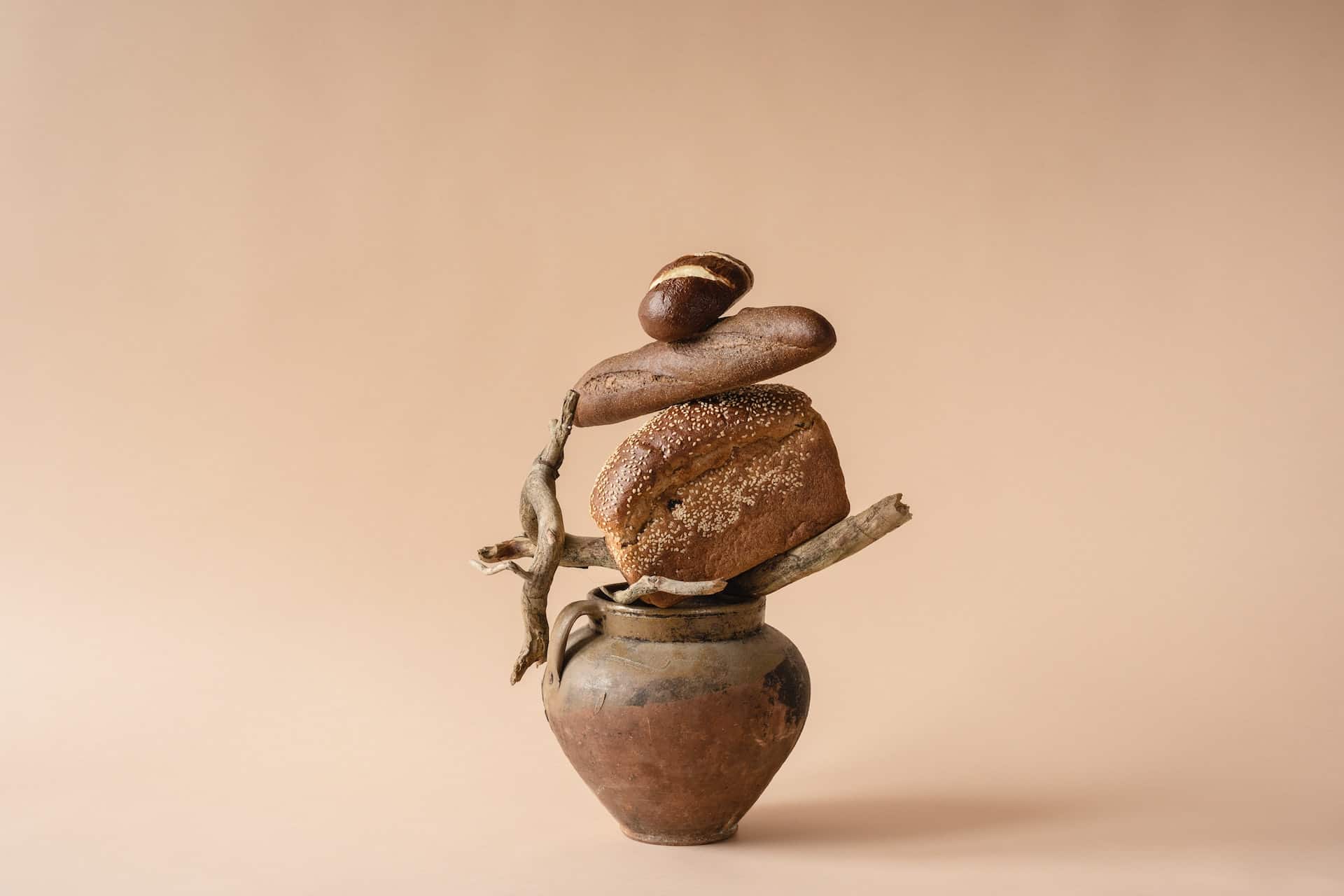 pieces of bread balanced on top of a brown vase