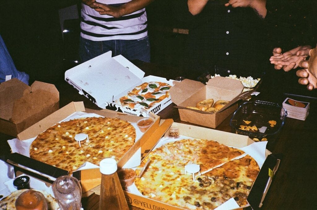 Teenage party ideas for food with three pizzas in a box