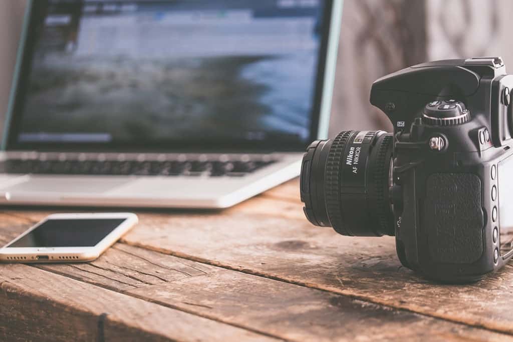 camera and laptop on desk