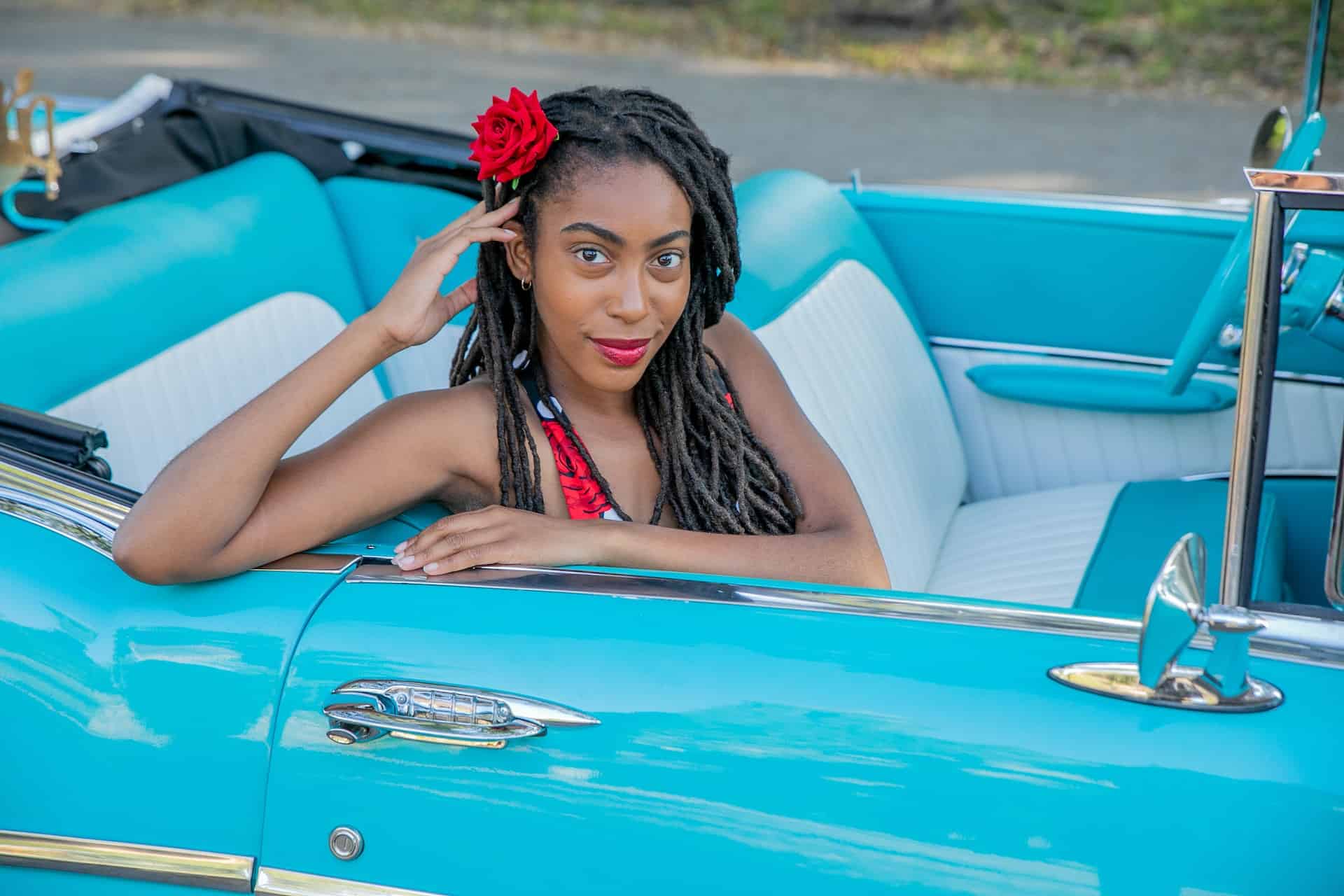 woman in blue convertible car