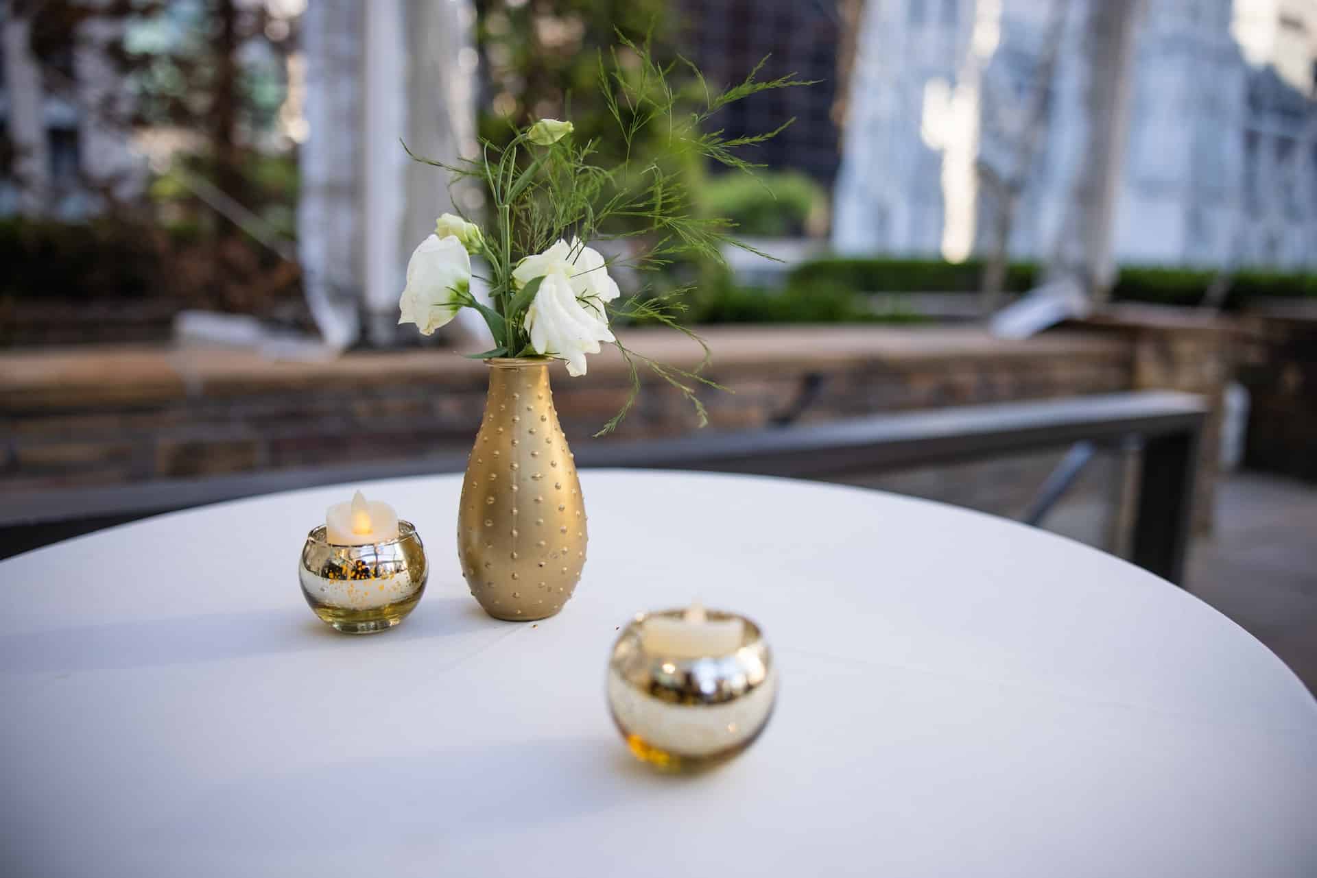 vase and candles on table