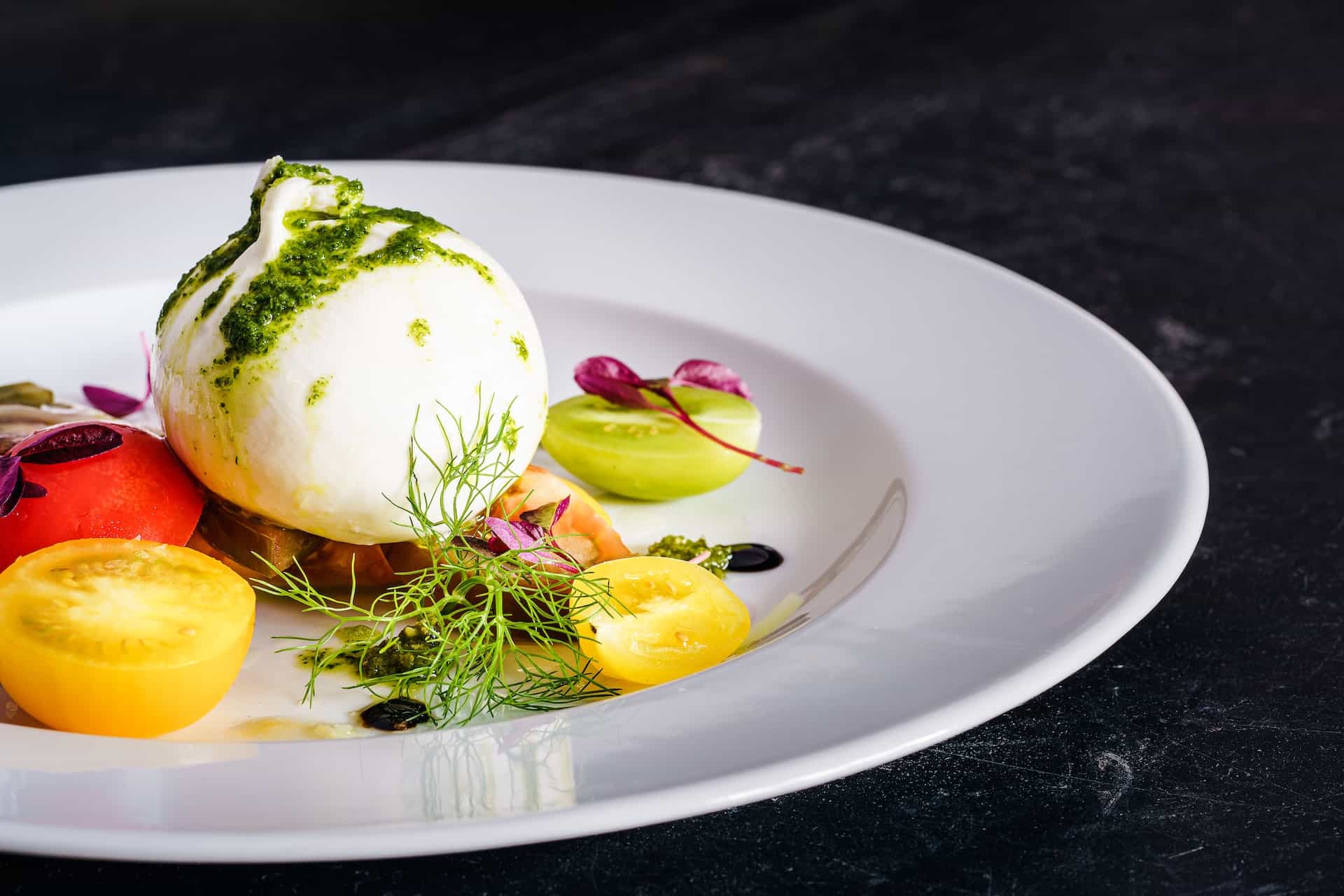 burrata on tomato salad on a plate