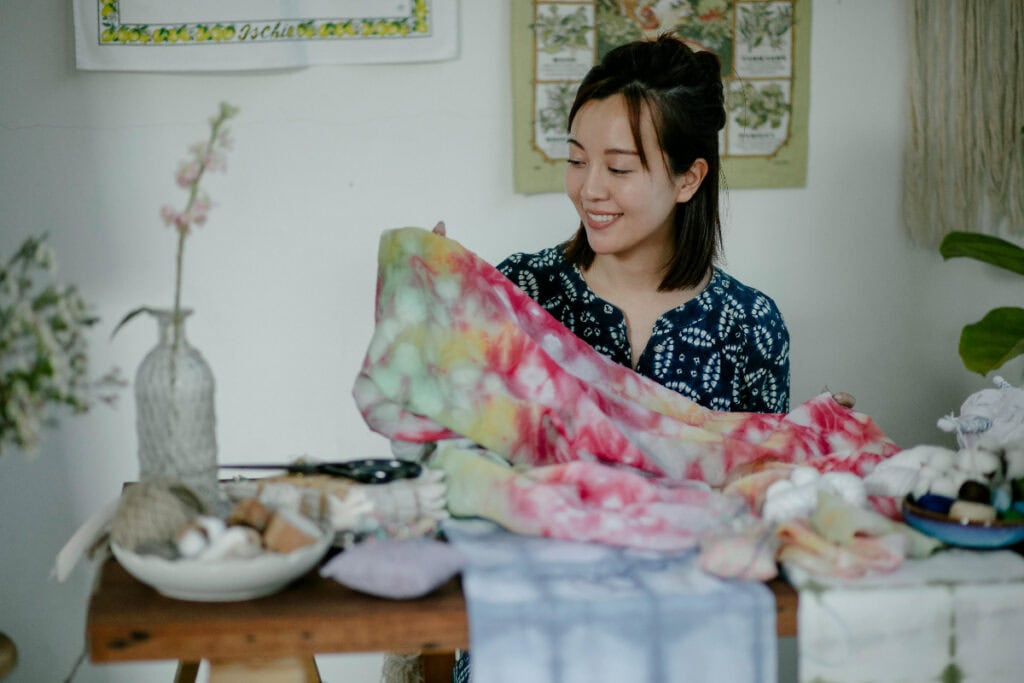 woman creating tie dye fabric