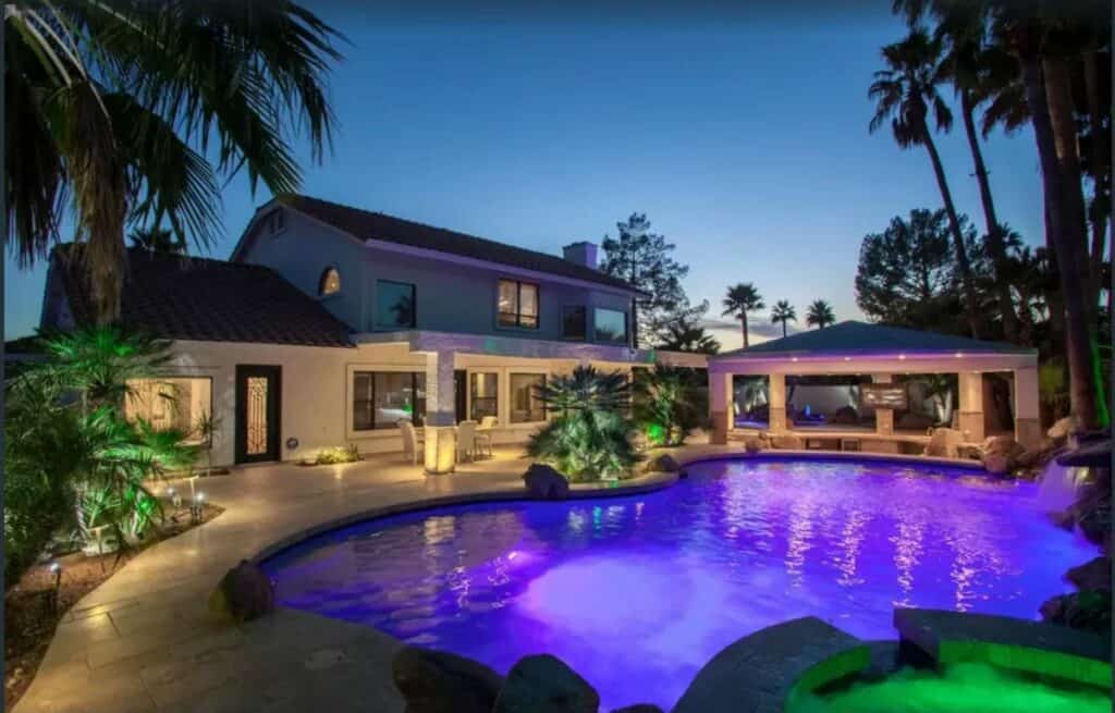 a mansion with a pool and hot tub