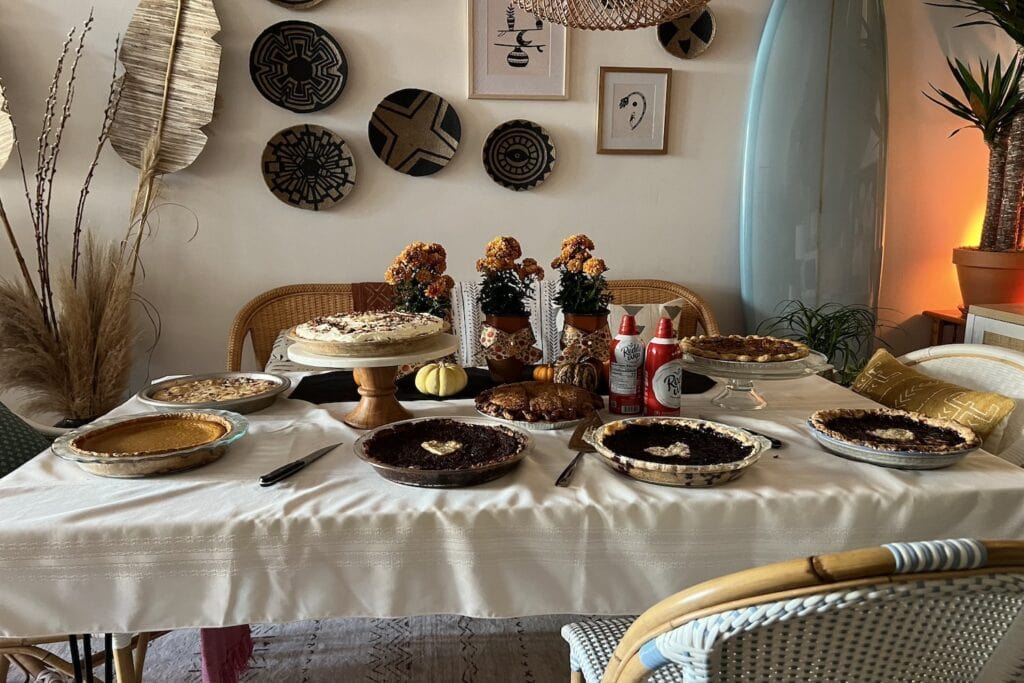 A selection of Thanksgiving pies sit on a dining table ready to be enjoyed