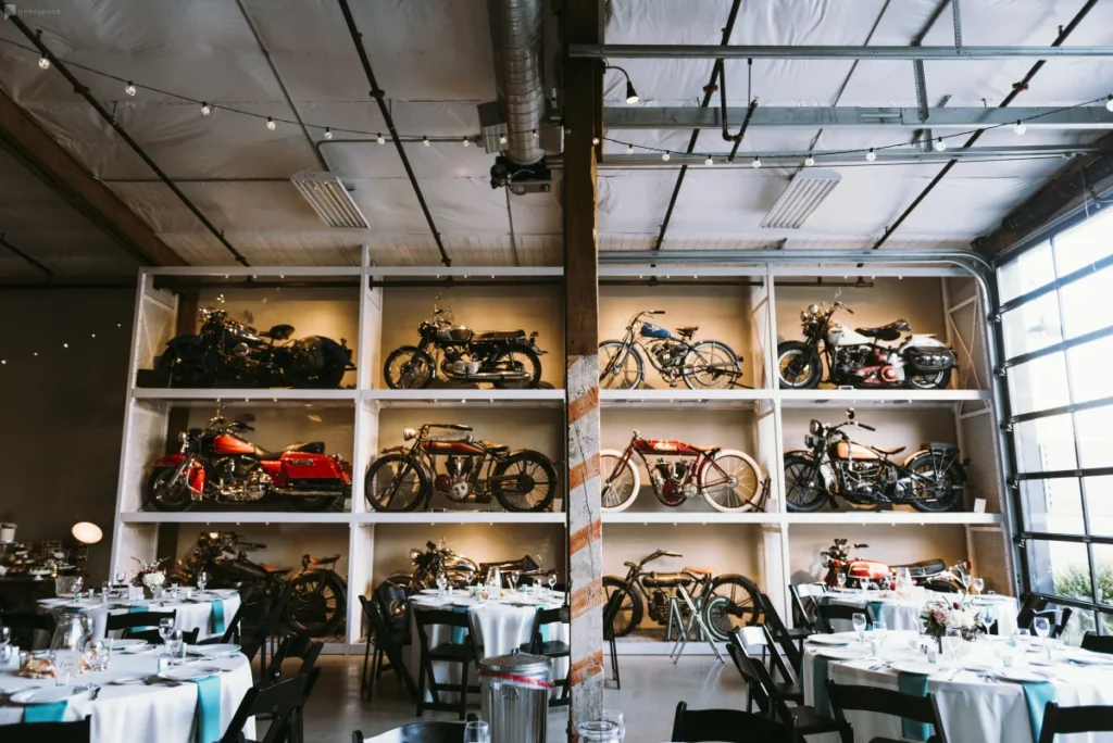 warehouse with vintage cars and motorcycles