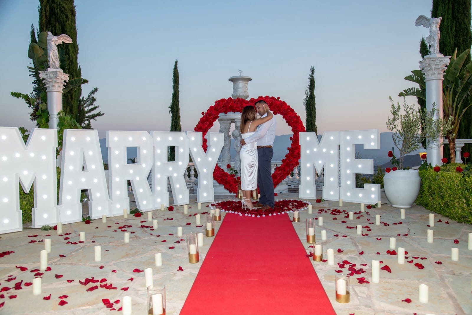 Outdoor rooftop proposal setup overlooking the Dallas skyline at sunset