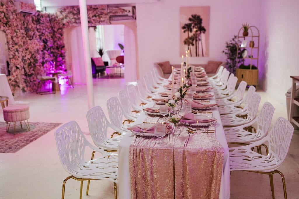 Pink flowers, furniture and linens decorate a romantic dining space