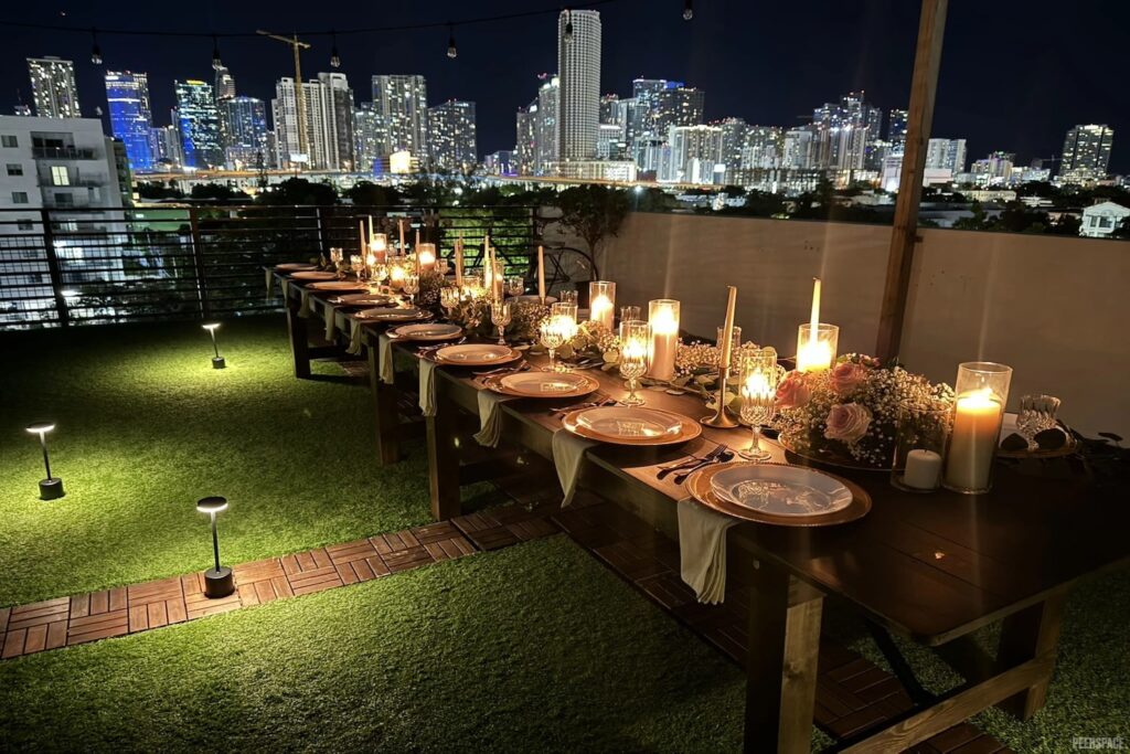 The city of Miami is the backdrop for an intimate wedding reception set up on a rooftop and lit up by candlelight
