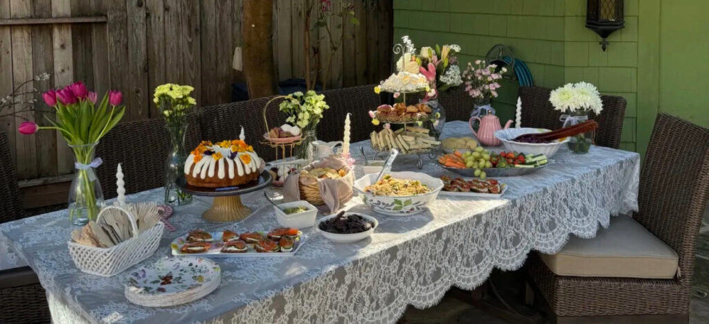 Outdoor table set with vintage-inspired decor and finger foods