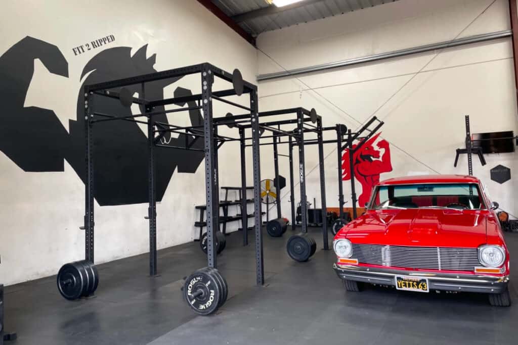 a fitness garage with a classic red sports car