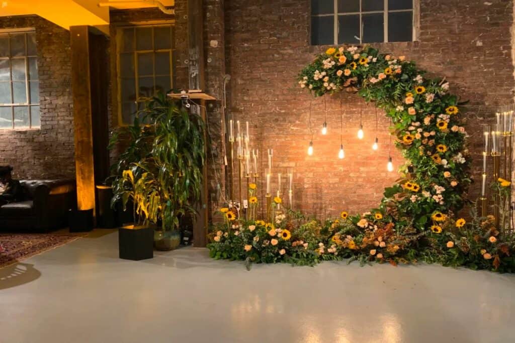 an exposed brick loft with a flower arch