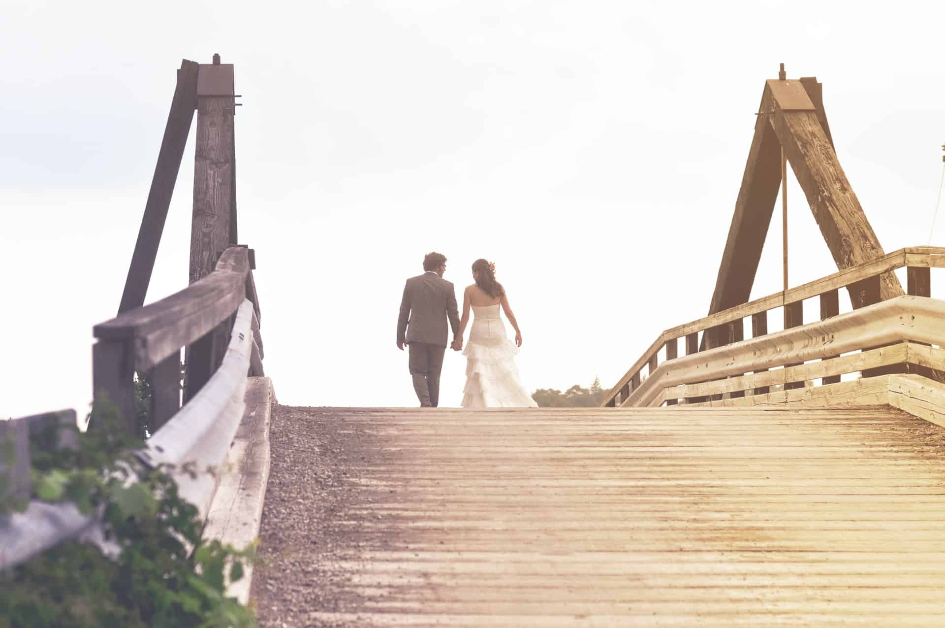 bride and groom on bridge
