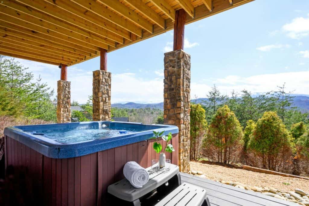 a hot tub outside a home with mountain views