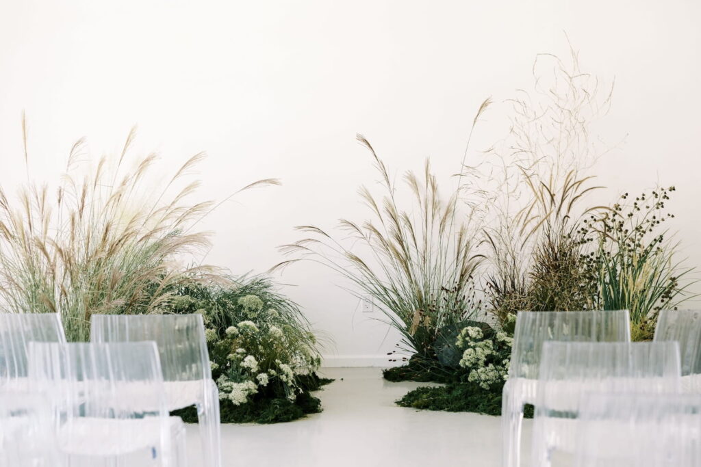 A simple bohemian-inspired wedding ceremony set up in all-white venue