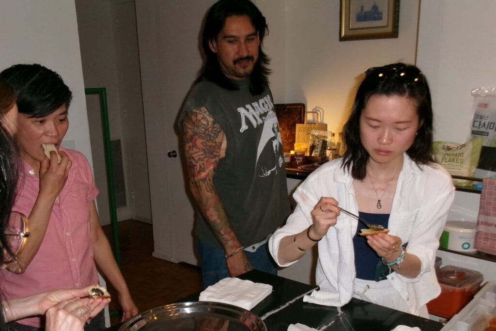 Image of people gathered in a kitchen testing some dishes