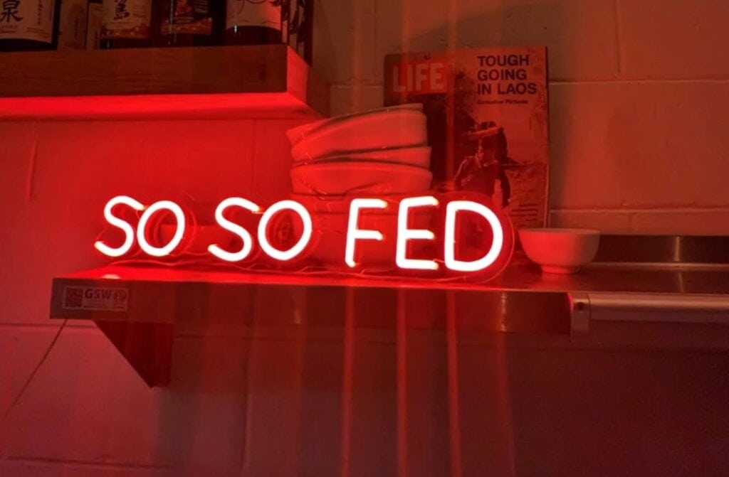 Neon sign for restaurant experience So So Fed