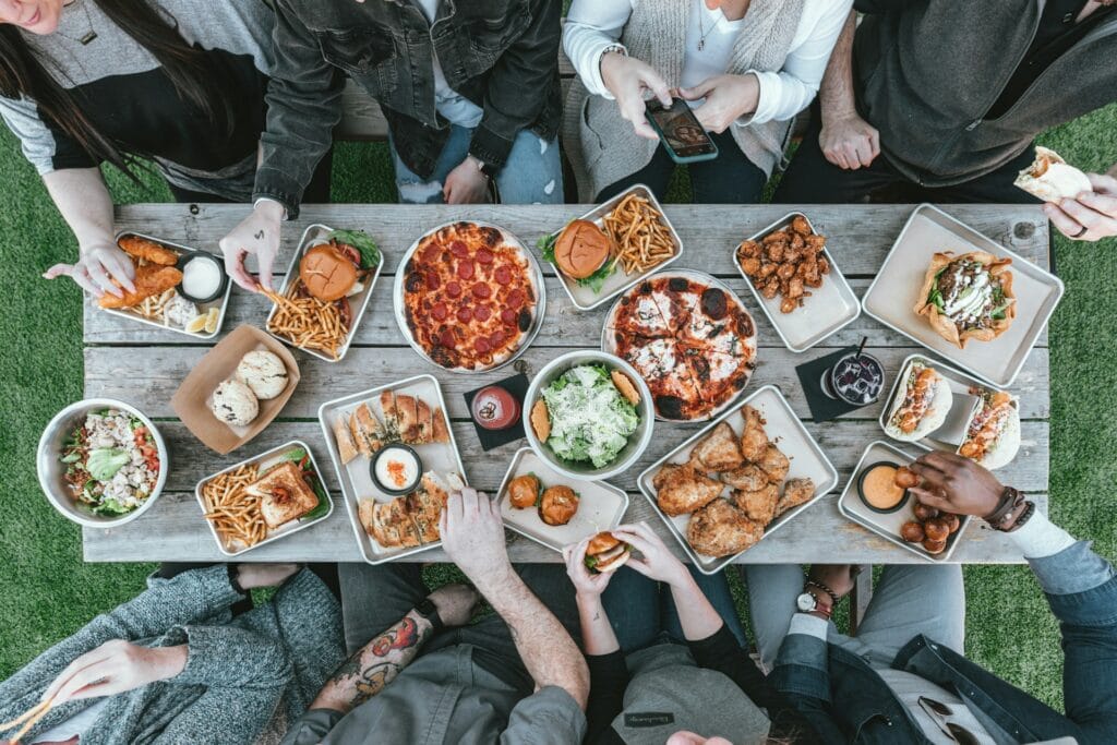 Aerial photo of divorce party food with pizza, wings, cookies