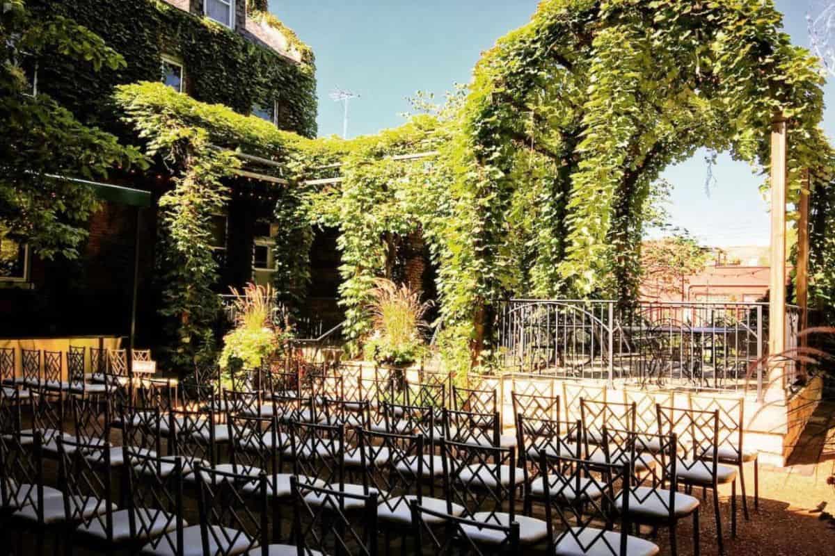outdoor venue with pergola and greenery