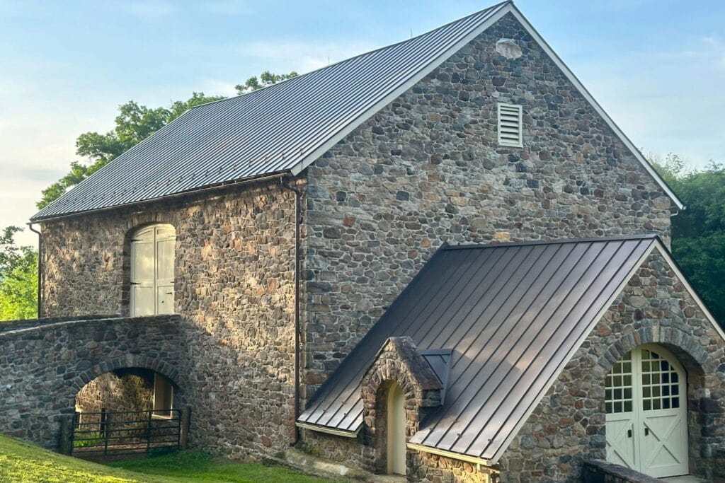 Rustic stone farmhouse with a tin roof on a farm in Pennsylvania