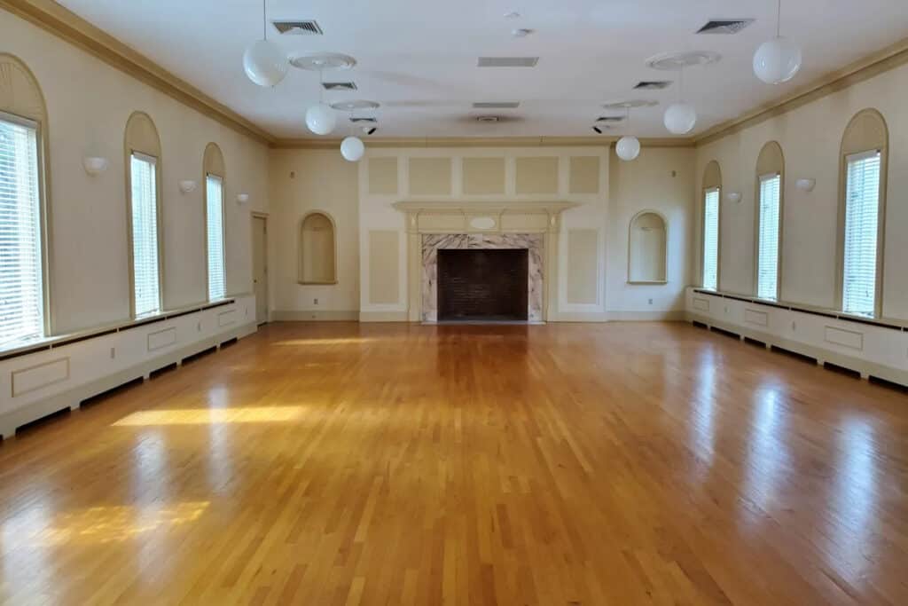 an all-white ballroom with wood floors