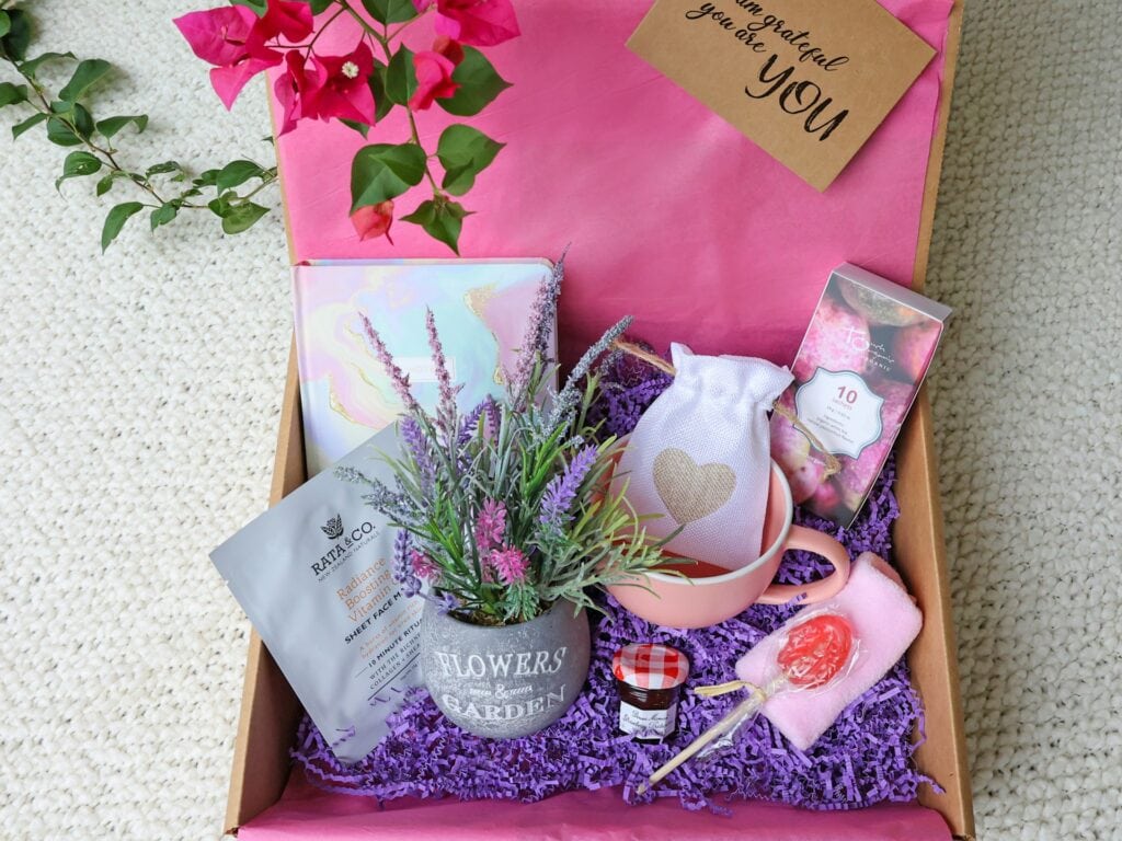 Galentine's day gift box with face mask, jam, journal, sachets, journal, and fake flowers
