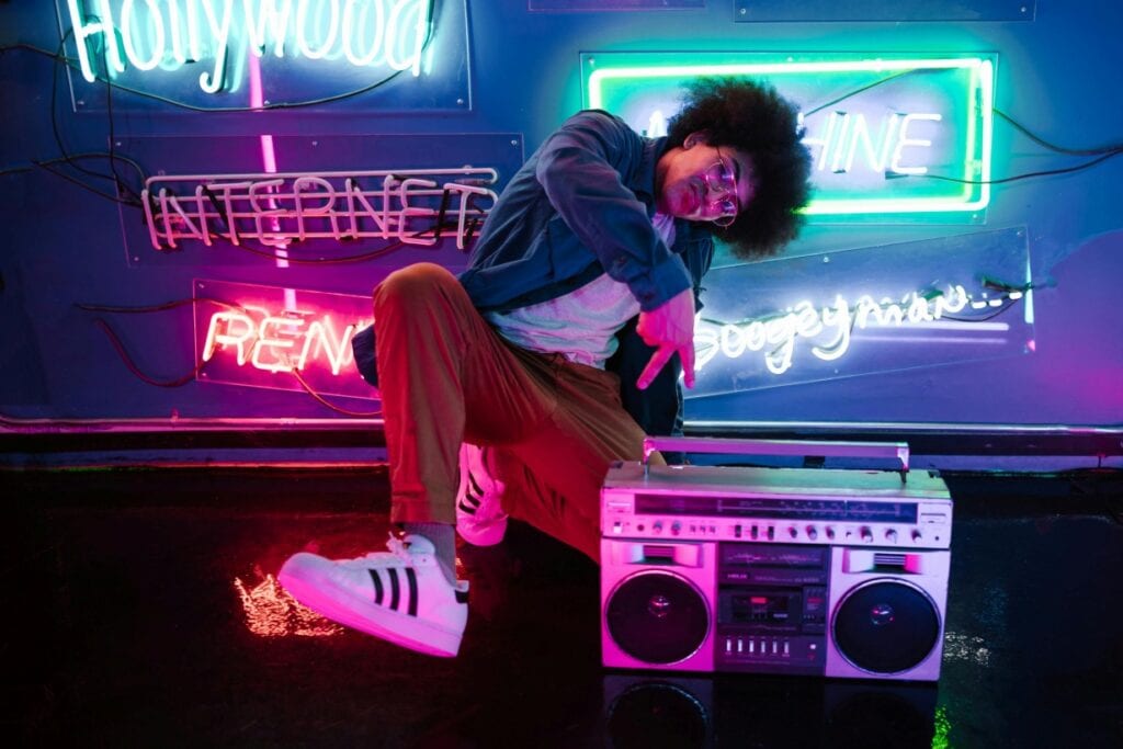 teen with a boombox and neon signs